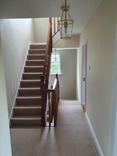 2 story of stairs banisters painted from white to a dark wood varnish 