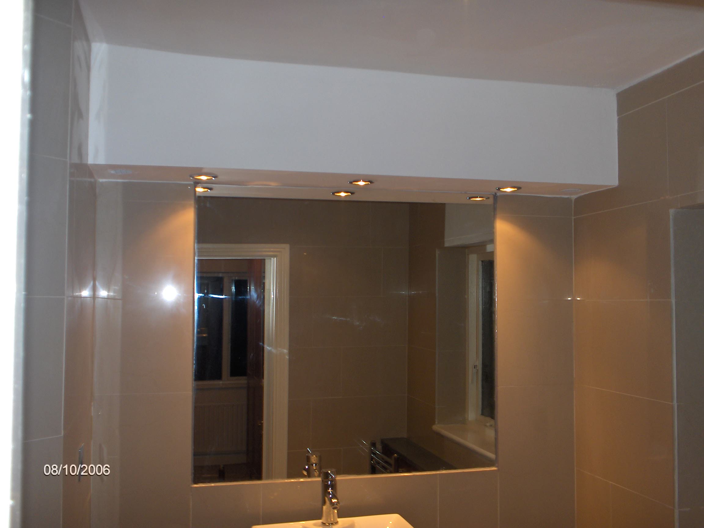 Main bathroom with hand made stone countertops. downlighters. chrome towel rail. 